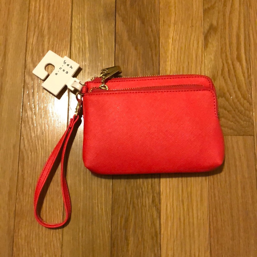 Brand new reddish/orange wristlet. NWT